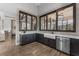Modern kitchenette features stainless steel appliances, dark cabinets, and stylish tiling at 7053 Painted Bunting Way, St Cloud, FL 34773