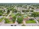 An aerial view of a neighborhood with mature trees, a swimming pool, and various backyard features on each property at 7124 Turquoise Ln, Orlando, FL 32807