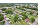 Aerial view showcasing a residential neighborhood with mature trees, pools, and proximity to commercial areas and roadways at 7124 Turquoise Ln, Orlando, FL 32807