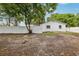 A spacious backyard with a white wall offering a private outdoor space for relaxation at 7124 Turquoise Ln, Orlando, FL 32807