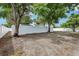 A spacious backyard with a white wall offering a private outdoor space for relaxation at 7124 Turquoise Ln, Orlando, FL 32807