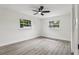This bedroom features plenty of natural light with two windows overlooking the yard at 7124 Turquoise Ln, Orlando, FL 32807
