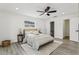 Bright bedroom with a ceiling fan, modern decor, light-toned walls and ensuite bathroom at 7124 Turquoise Ln, Orlando, FL 32807