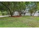 A well-maintained yard with a neatly trimmed lawn and trees surrounding a beautiful home at 7124 Turquoise Ln, Orlando, FL 32807