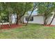 A well-maintained yard with a neatly trimmed lawn and trees surrounding a beautiful home at 7124 Turquoise Ln, Orlando, FL 32807