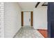 Inviting front porch with decorative tile flooring, a white brick wall, and a modern-style front door at 7124 Turquoise Ln, Orlando, FL 32807