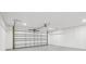 Spacious garage with a white door and room for multiple cars or storage at 7124 Turquoise Ln, Orlando, FL 32807
