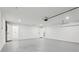 Spacious garage with white painted walls and flooring, showcasing ample space at 7124 Turquoise Ln, Orlando, FL 32807