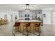Open kitchen features gray cabinets, island with seating, and stainless steel appliances at 7124 Turquoise Ln, Orlando, FL 32807