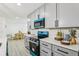 Bright modern kitchen with sleek countertops, stainless steel appliances, and gray cabinets at 7124 Turquoise Ln, Orlando, FL 32807