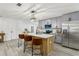 Open kitchen features gray cabinets, island with seating, and stainless steel appliances at 7124 Turquoise Ln, Orlando, FL 32807