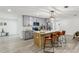 Modern kitchen features gray cabinets, island with seating, and stainless steel appliances at 7124 Turquoise Ln, Orlando, FL 32807