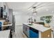 Modern kitchen features gray cabinets, an island, and stainless steel appliances, creating a sleek design at 7124 Turquoise Ln, Orlando, FL 32807