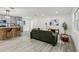Spacious open-concept living room with stylish floors and furniture that flows into the modern kitchen at 7124 Turquoise Ln, Orlando, FL 32807