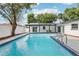 A backyard featuring a sparkling pool and a covered patio with a view of the lush greenery at 7124 Turquoise Ln, Orlando, FL 32807