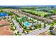 Aerial view of the community featuring a swimming pool, lake, green spaces and walking trails at 877 Ocean Course Ave, Davenport, FL 33896