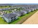 Community aerial view featuring modern two-story homes, playgrounds, and green spaces in a Gathering-friendly setting at 877 Ocean Course Ave, Davenport, FL 33896