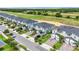 Aerial view of luxury townhomes overlooking a golf course with lush landscaping and manicured lawns at 877 Ocean Course Ave, Davenport, FL 33896