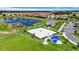 Aerial view of the community with lake, volley ball court, parking and an outdoor seating area at 877 Ocean Course Ave, Davenport, FL 33896