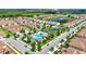 Aerial view of the community featuring a swimming pool, palm trees, cabana, and lush landscaping at 877 Ocean Course Ave, Davenport, FL 33896