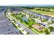 Aerial view of the community featuring manicured lawns, playground, tennis court, basketball court, and sidewalks at 877 Ocean Course Ave, Davenport, FL 33896