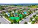 Aerial view of community featuring a pool, playground, green space, shaded seating areas, and lush landscaping at 877 Ocean Course Ave, Davenport, FL 33896