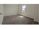 Bedroom with plush carpeting, light walls, and a bright window at 877 Ocean Course Ave, Davenport, FL 33896
