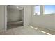 Bright bedroom featuring tile floors, two windows, and neutral paint at 877 Ocean Course Ave, Davenport, FL 33896