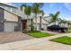 Modern townhomes feature stone accents, attached garages, and well-manicured lawns at 877 Ocean Course Ave, Davenport, FL 33896