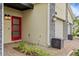 A red front door stands out against the neutral tones with upgraded lighting at 877 Ocean Course Ave, Davenport, FL 33896