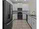 A stylish kitchen features stainless appliances, gray counters and tile flooring at 877 Ocean Course Ave, Davenport, FL 33896