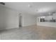 Open-concept living room with tile floors connects to a modern kitchen at 877 Ocean Course Ave, Davenport, FL 33896