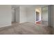 Neutral living room featuring plush carpeting and access to covered porch at 877 Ocean Course Ave, Davenport, FL 33896