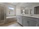 Bright main bathroom showcasing a double sink vanity, soaking tub, and tiled shower at 877 Ocean Course Ave, Davenport, FL 33896