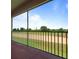 Enjoy picturesque golf course views from this condo's screened patio with black metal railings and ample natural light at 877 Ocean Course Ave, Davenport, FL 33896