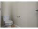 Powder room featuring toilet, toilet paper holder, and neutral walls at 877 Ocean Course Ave, Davenport, FL 33896