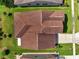 Aerial view showcasing the roof, backyard, and surrounding landscaping of this well-maintained property at 921 Costa Mesa Ln, Kissimmee, FL 34744