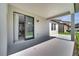 A covered back patio has plenty of room for furniture, with a sliding door entry into the home at 921 Costa Mesa Ln, Kissimmee, FL 34744