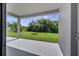 A covered back patio overlooks the lawn and surrounding foliage at 921 Costa Mesa Ln, Kissimmee, FL 34744