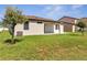 A well-maintained backyard features a lush lawn and a covered patio, perfect for outdoor relaxation at 921 Costa Mesa Ln, Kissimmee, FL 34744