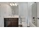 Well-lit bathroom features a single vanity, tiled floors, a commode, and a shower-tub combination at 921 Costa Mesa Ln, Kissimmee, FL 34744