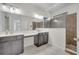 Bathroom boasts double sinks, sleek cabinetry, and a modern tiled shower for a luxurious experience at 921 Costa Mesa Ln, Kissimmee, FL 34744