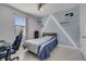 Cozy bedroom with playful wall decor, featuring a comfortable bed and ample natural light at 921 Costa Mesa Ln, Kissimmee, FL 34744