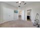 Cozy bedroom with carpet floors, a ceiling fan, and closet doors, plus a TV on the wall at 921 Costa Mesa Ln, Kissimmee, FL 34744