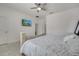 Bedroom featuring tile floors, ceiling fan, and a large window at 921 Costa Mesa Ln, Kissimmee, FL 34744