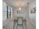 Dining room with modern lighting fixture and large window with lots of natural light at 921 Costa Mesa Ln, Kissimmee, FL 34744