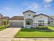 Charming single-Gathering home features a well-manicured lawn and attached two-car garage at 921 Costa Mesa Ln, Kissimmee, FL 34744
