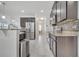 Modern kitchen featuring stainless steel appliances and dark cabinetry at 921 Costa Mesa Ln, Kissimmee, FL 34744