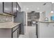 Kitchen features dark cabinets and stainless appliances at 921 Costa Mesa Ln, Kissimmee, FL 34744