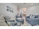 Bright living room with comfortable blue seating and stylish decor at 921 Costa Mesa Ln, Kissimmee, FL 34744